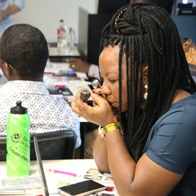 A visiting student from Africa examines a gem stone.